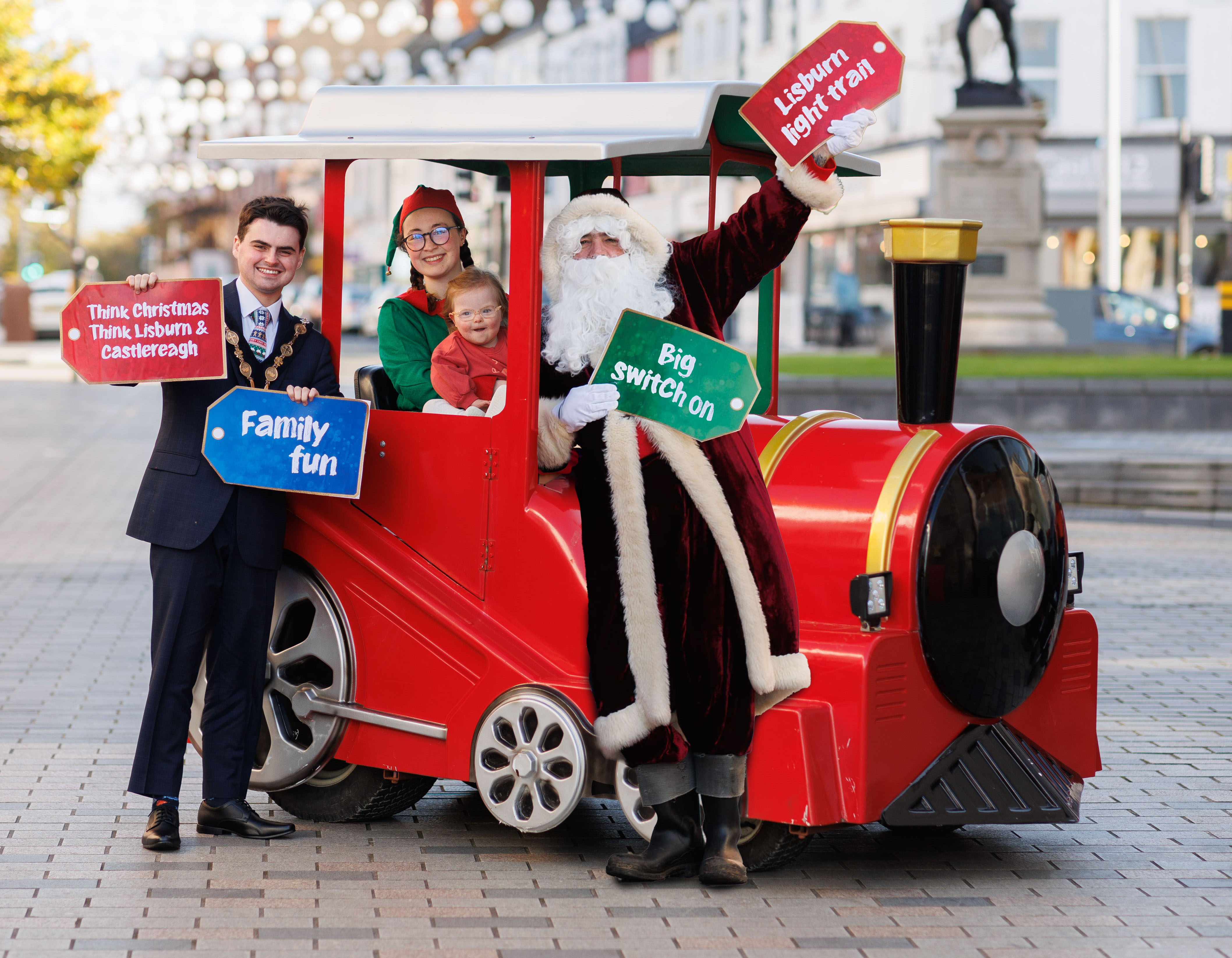 Three-year-old Bríd Devine boarded the Lisburn Lights Express for its maiden journey along Bow Street with Mayor Dickson, Santa Clause and his Elf.