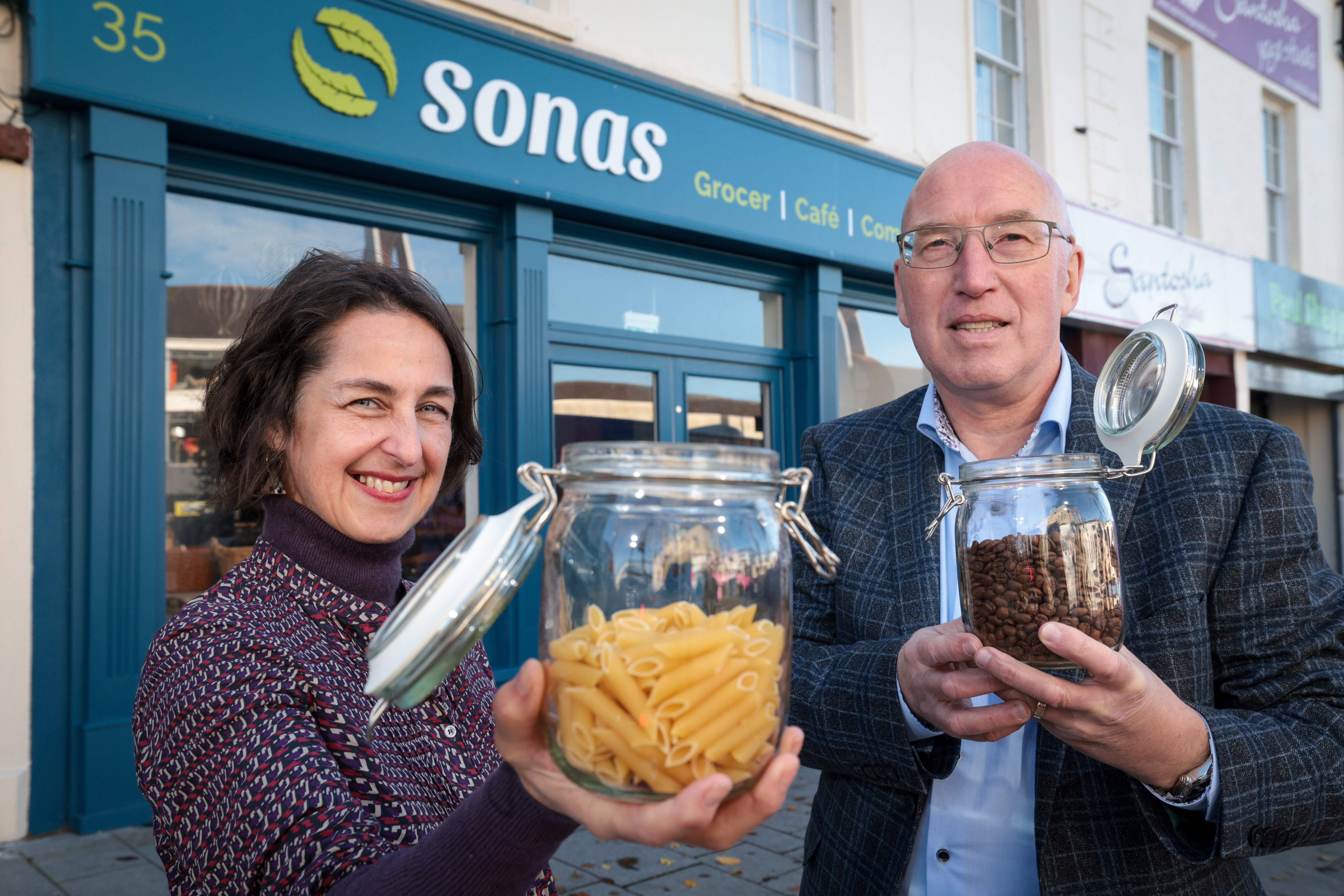 Image of Julie and Councillor Laverty BEM demonstrating refillable produce jars